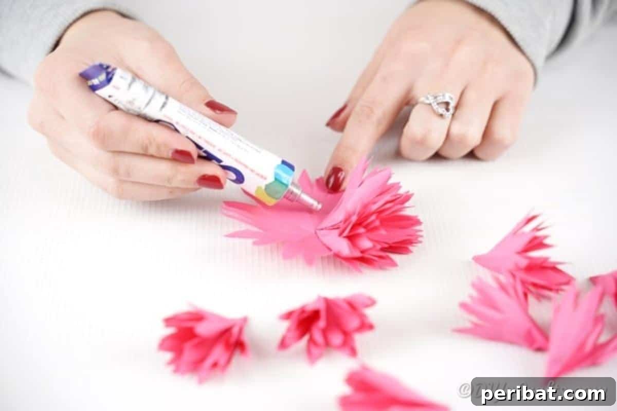 Attaching paper flower pieces together with glue