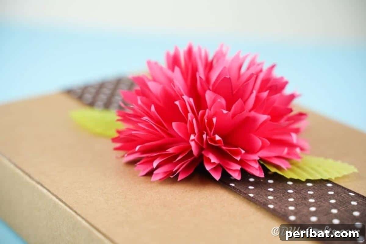 Pink paper flower on top of brown cardboard box