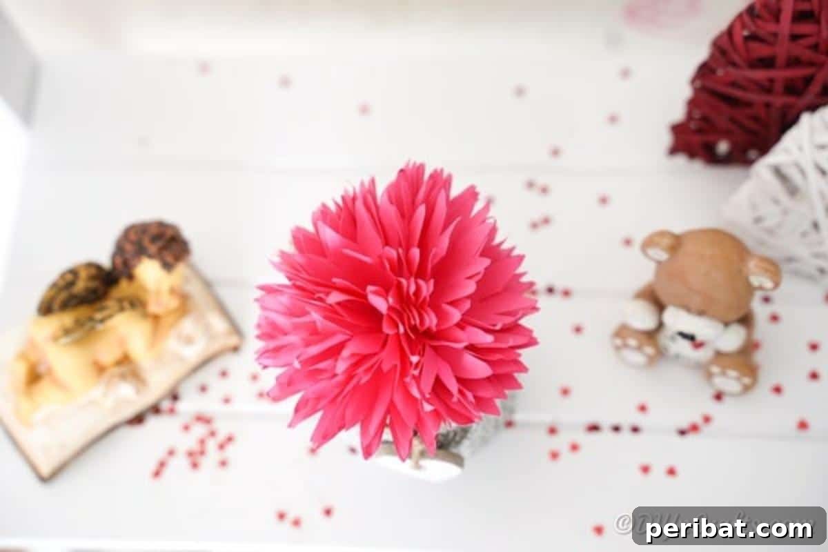 Paper flower on white table with confetti