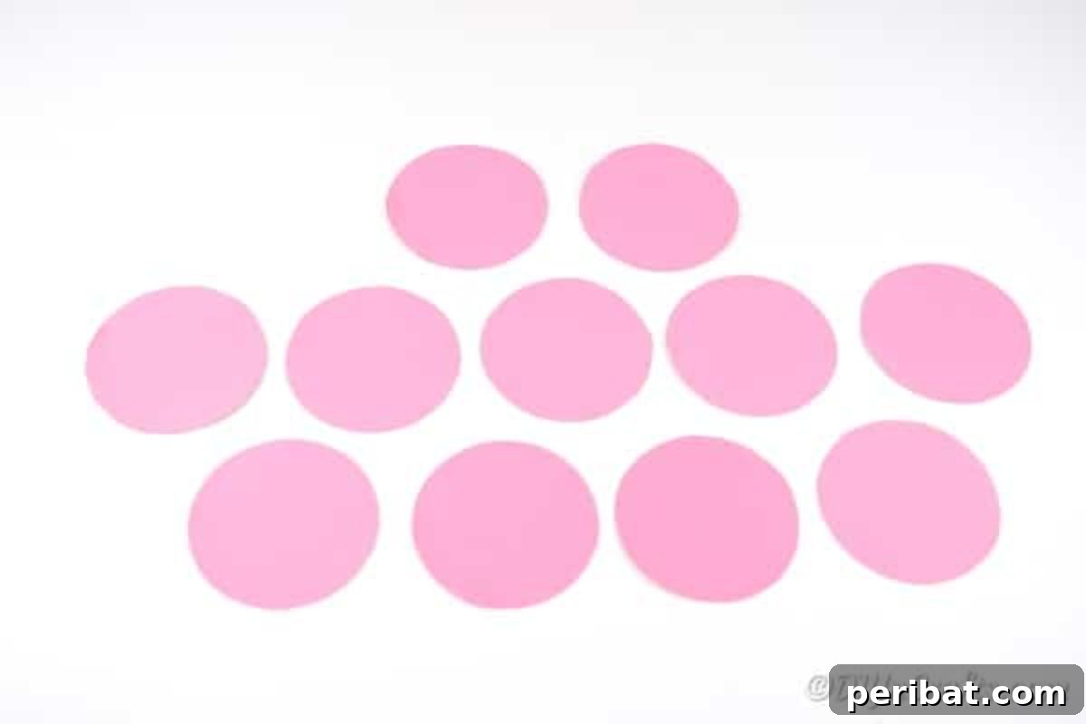 Several pink paper circles on white surface