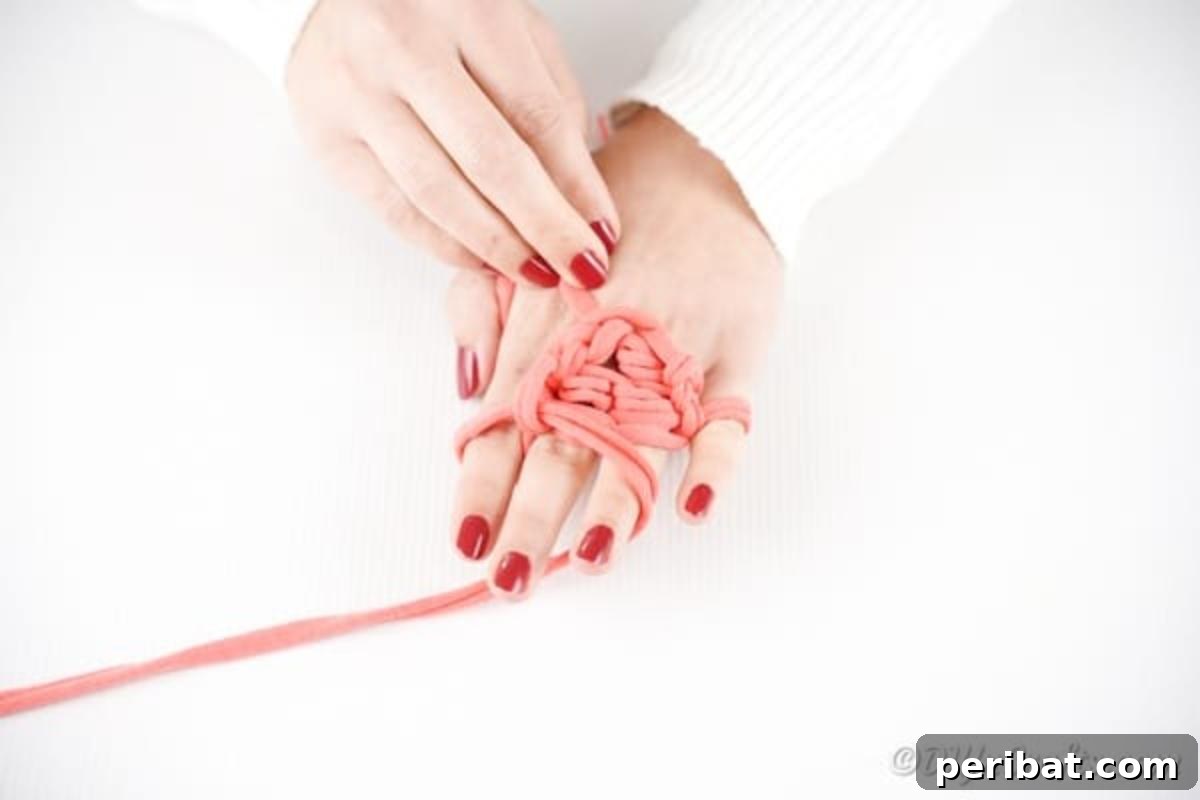 Effortless Elegance: Finger Knit Necklace DIY Video Tutorial 12 A finished length of finger knitted yarn, ready to be secured and formed into a necklace.