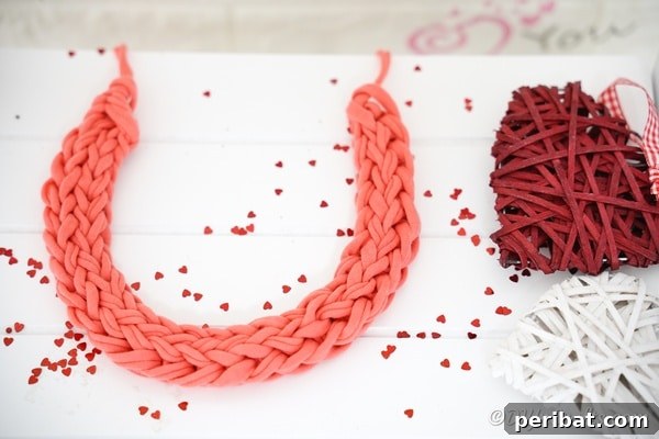 A beautifully arranged yarn necklace on a white table, capturing the essence of handmade crafts.