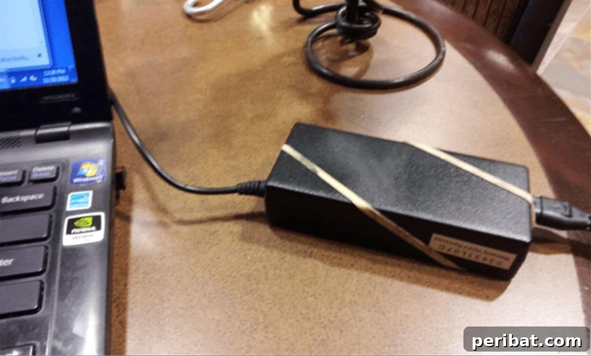 15 Smart Rubber Band Tricks for an Easier Everyday 6 Laptop power brick with rubber bands to prevent slipping off the desk