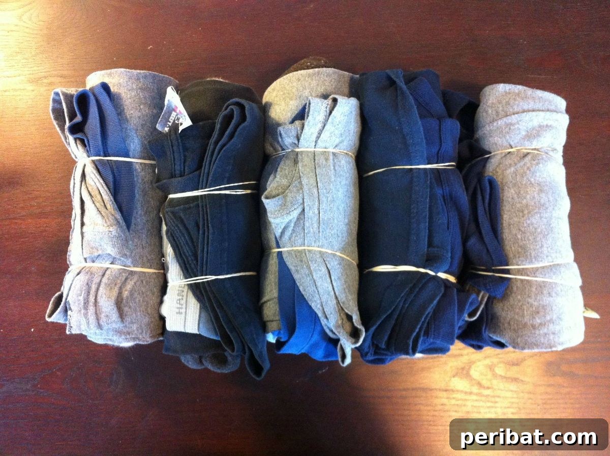 15 Smart Rubber Band Tricks for an Easier Everyday 8 Clothes rolled and secured with rubber bands for compact packing