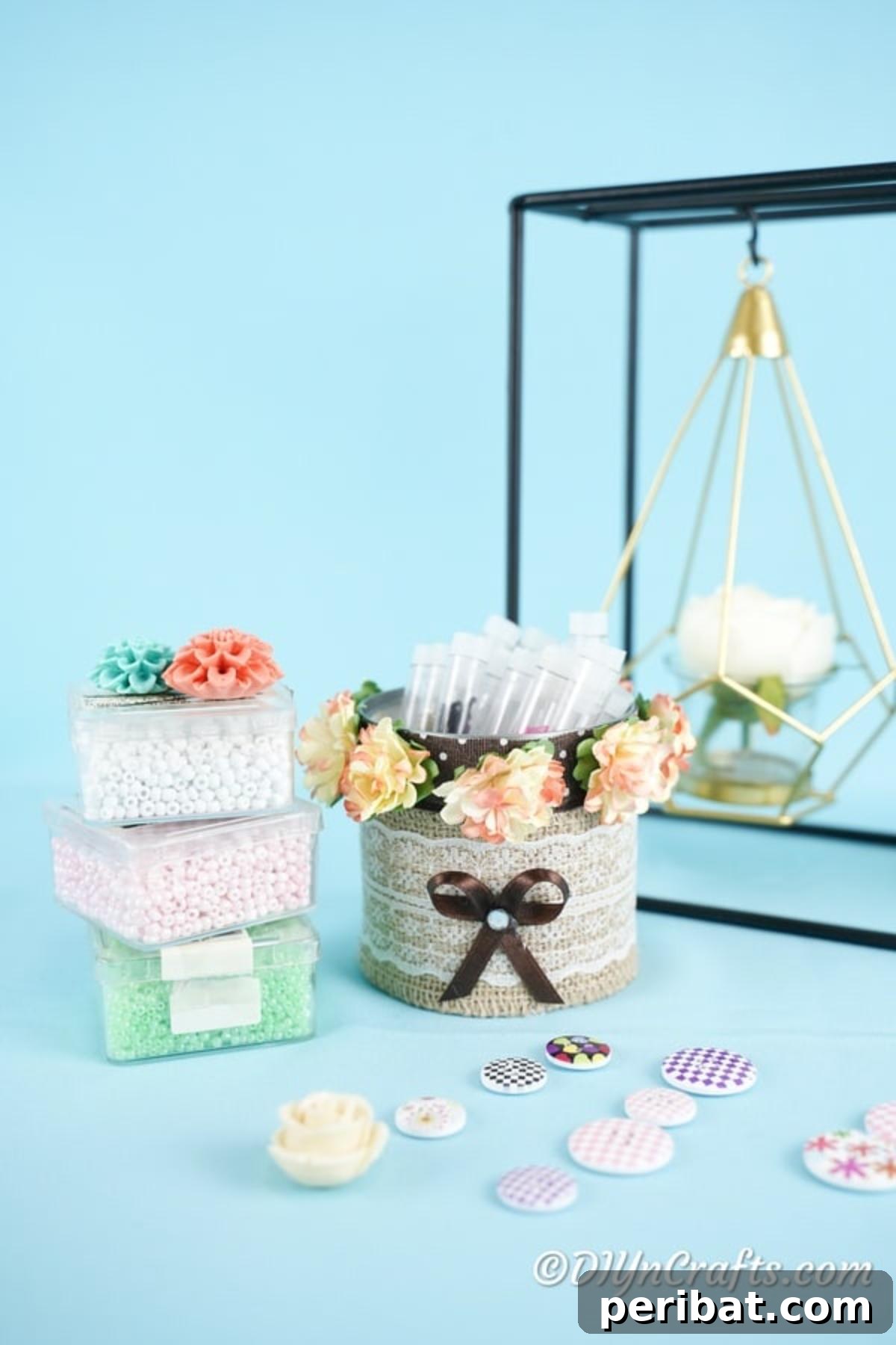 Chic Burlap Lace Accent Canister 15 Completed decorative storage can with burlap, lace, and flowers, displayed on a blue surface with beads
