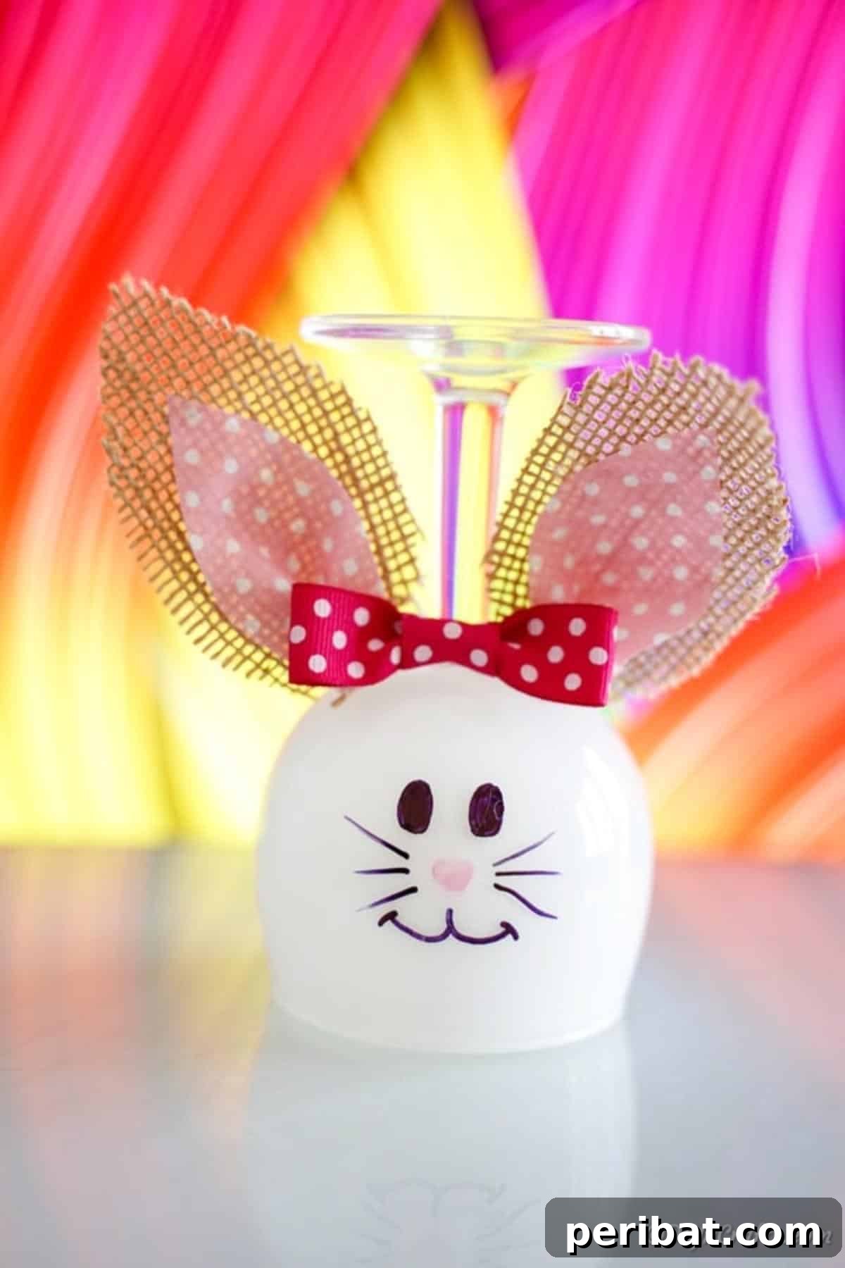 Hoppy Wine Glass Bunny Decor Tutorial 3 An Easter bunny wine glass decoration set against a vibrant, colorful background.