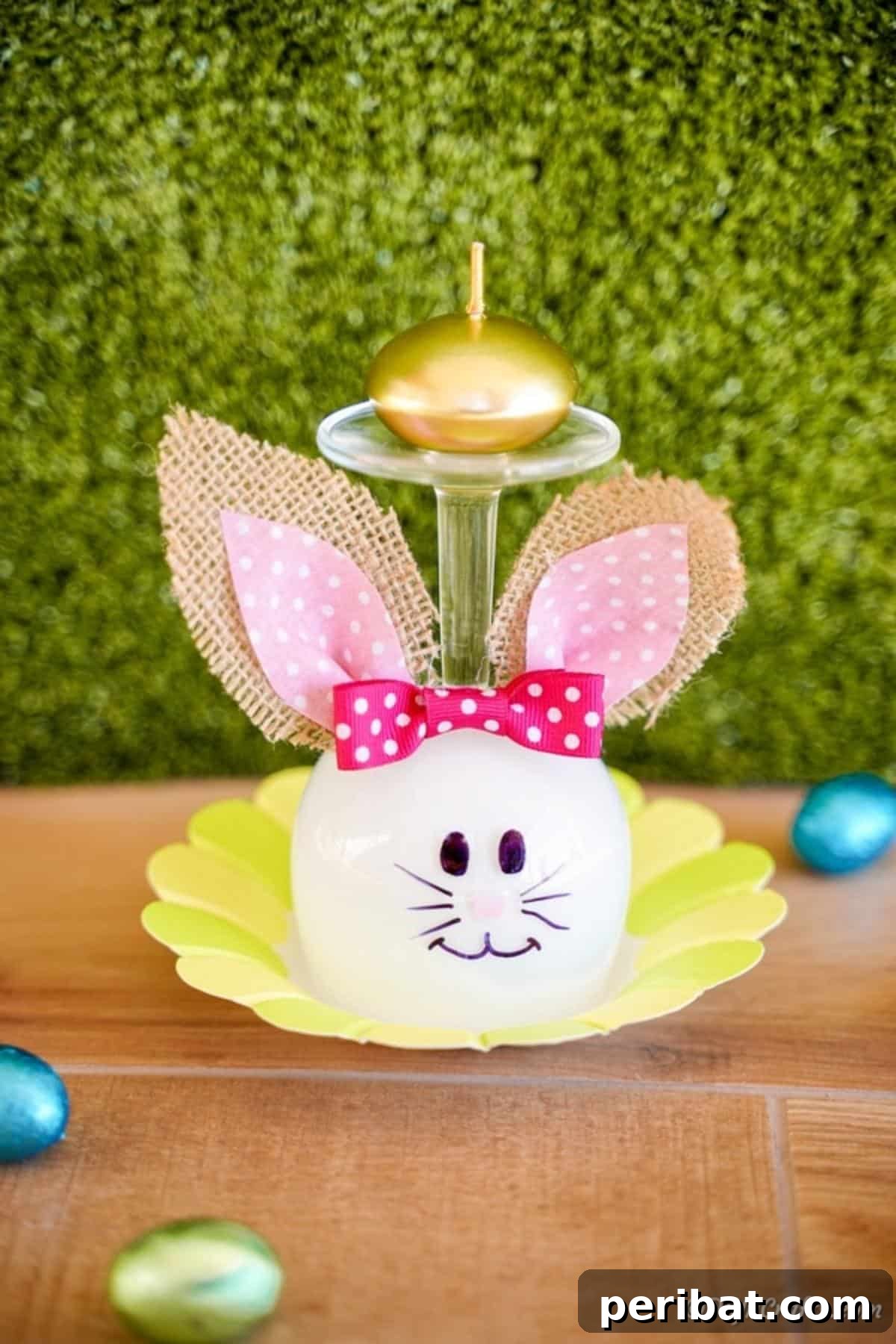 Hoppy Wine Glass Bunny Decor Tutorial 4 A wine glass bunny decoration placed on a bright yellow mat.