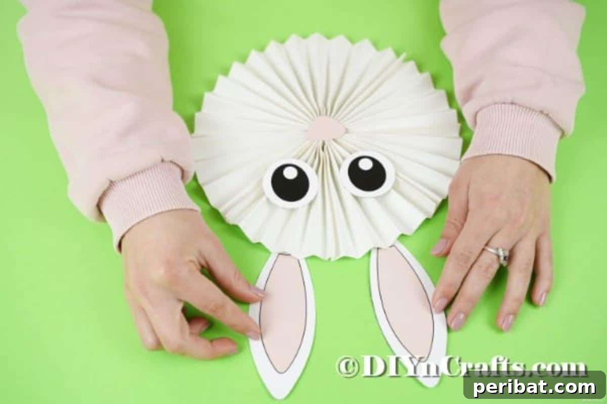 Gluing bunny ears onto the paper bunny
