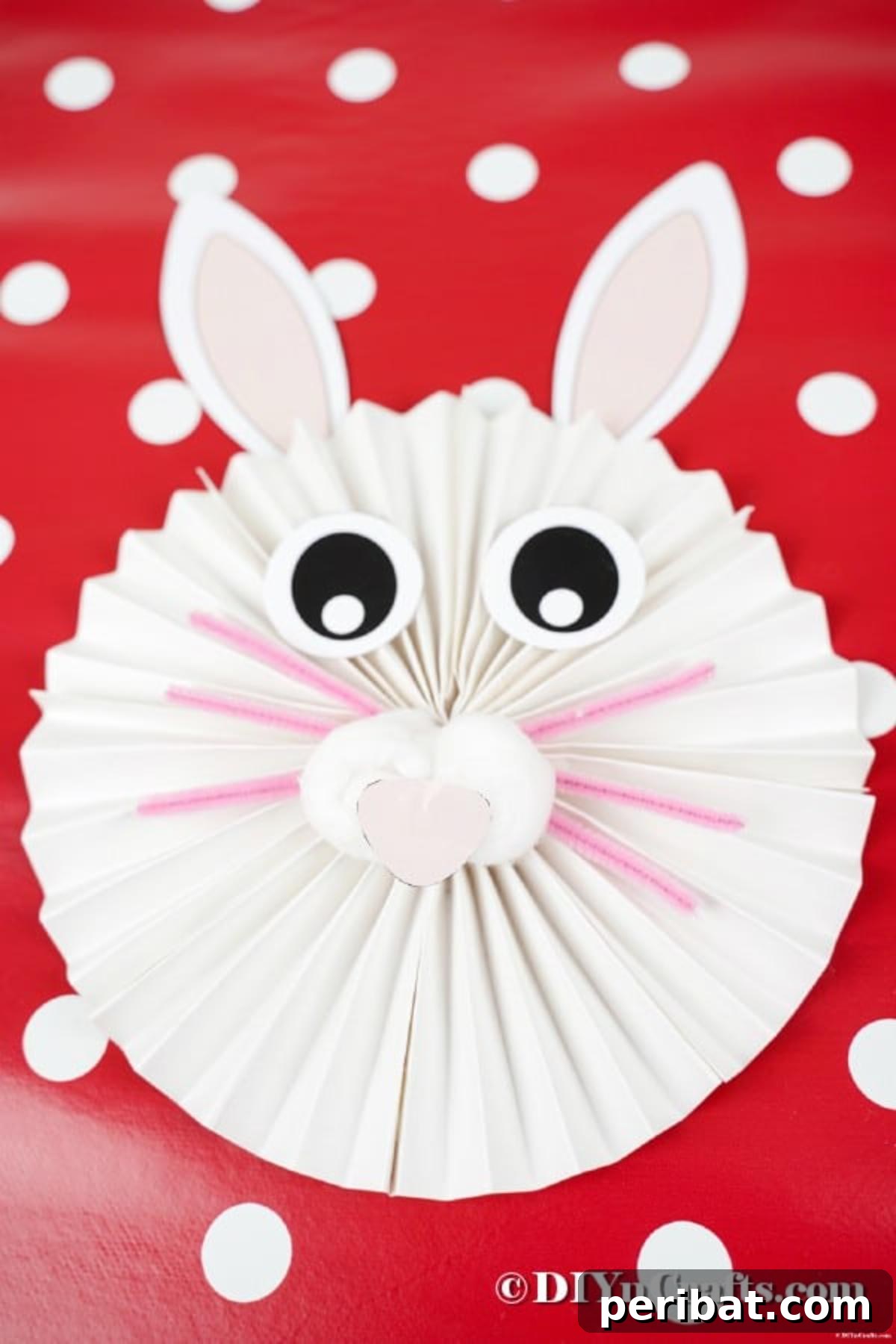 Paper bunny on red and white polka dot background