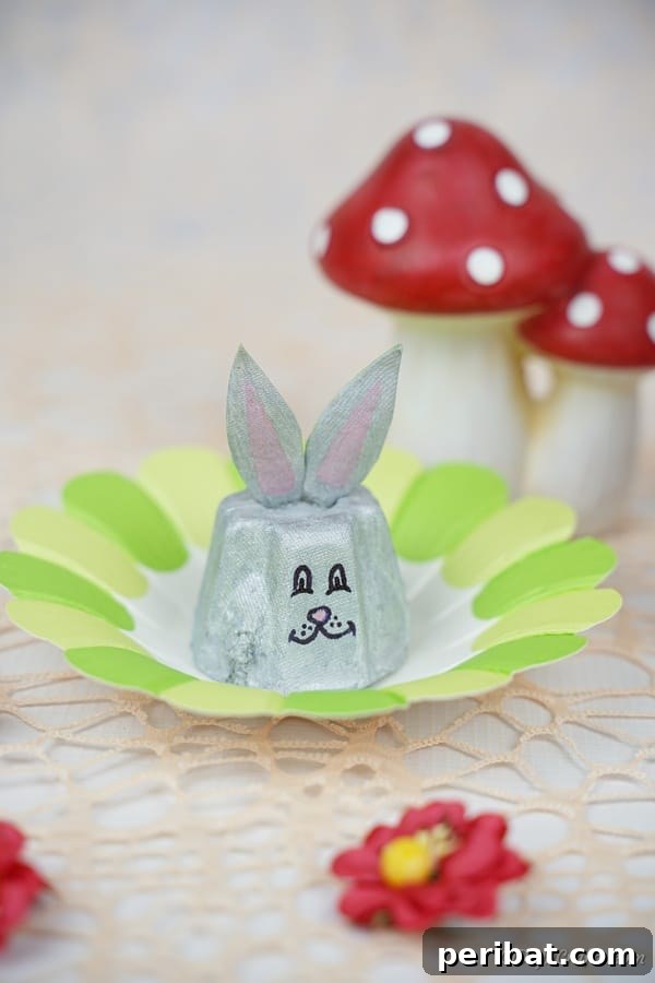 Adorable Upcycled Egg Carton Easter Bunny Craft 22 Egg carton bunny on green paper flower
