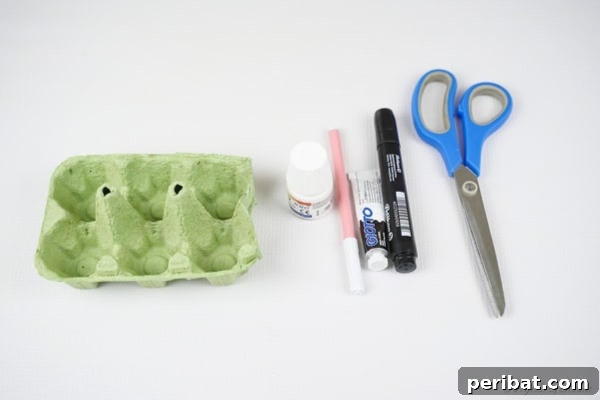Adorable Upcycled Egg Carton Easter Bunny Craft 7 A flat lay of all the essential supplies needed for the egg carton Easter bunny craft, including an egg carton, paints, pens, scissors, and glue, laid out neatly.