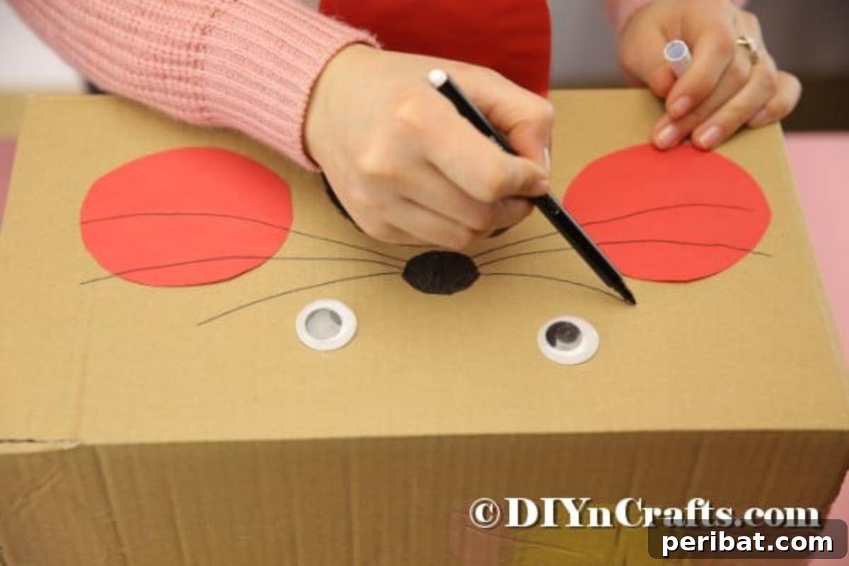 Hoppy Easter Box Ball Toss 15 Drawing the bunny's nose and whiskers with a black marker.