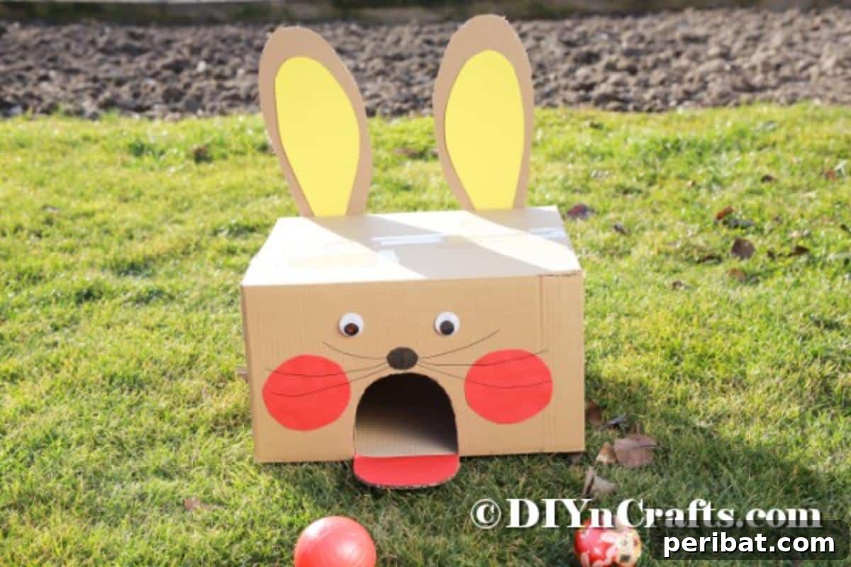Hoppy Easter Box Ball Toss 3 Handmade cardboard box bunny on green grass ready for Easter fun.