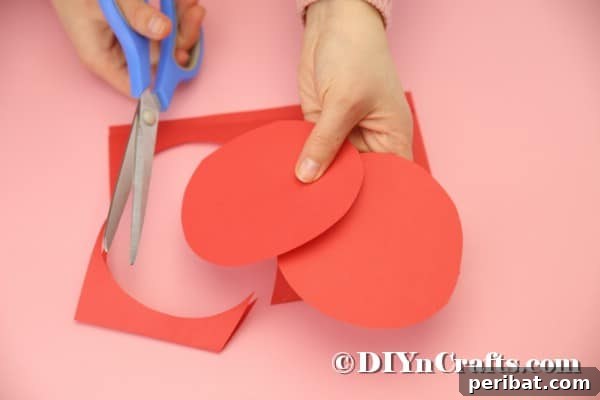 Hoppy Easter Box Ball Toss 26 Cutting circles from red paper