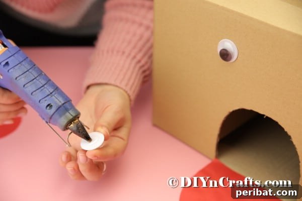 Hoppy Easter Box Ball Toss 27 Gluing googly eyes onto cardboard box