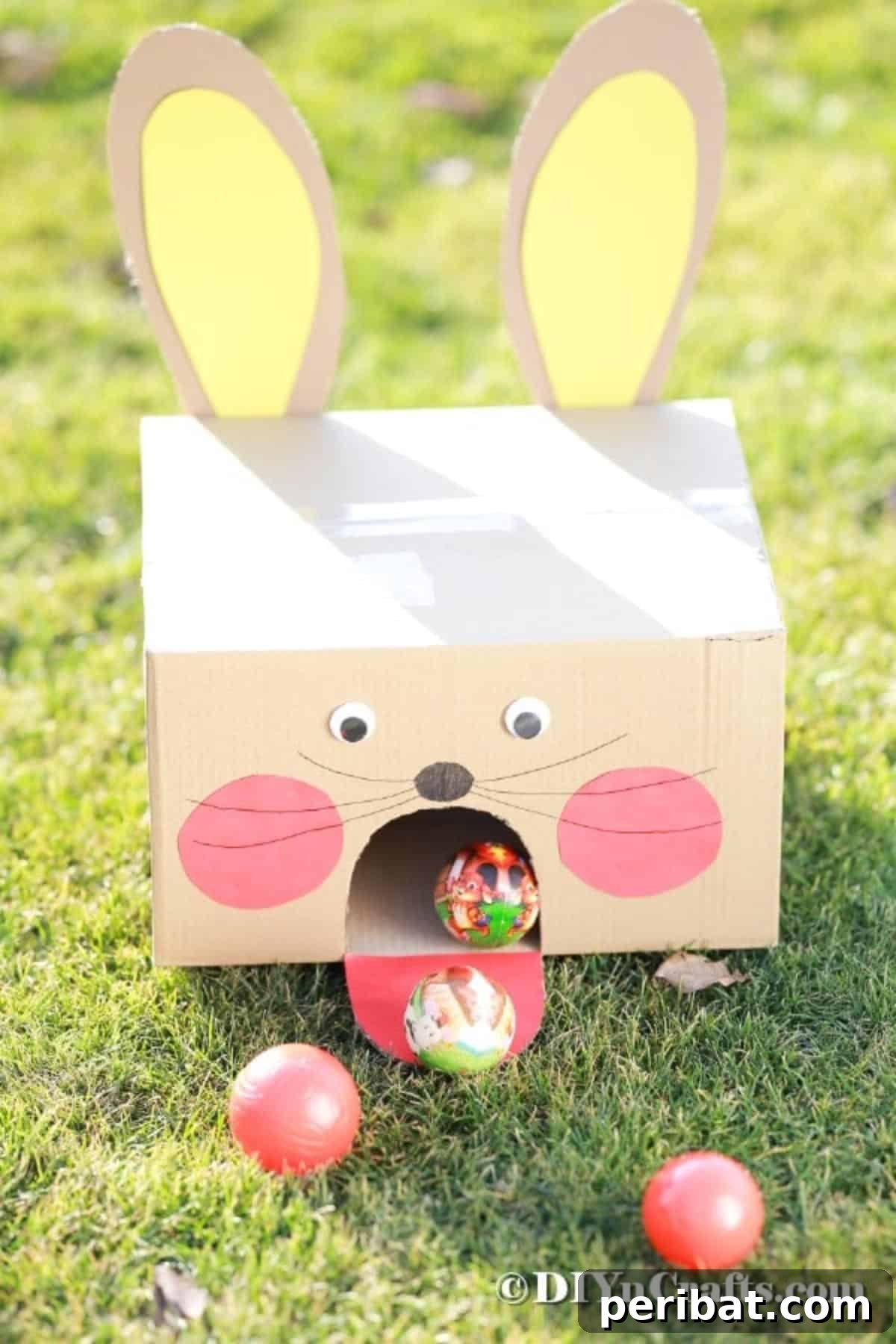 Hoppy Easter Box Ball Toss 4 Finished cardboard bunny ball toss game setup on green grass.