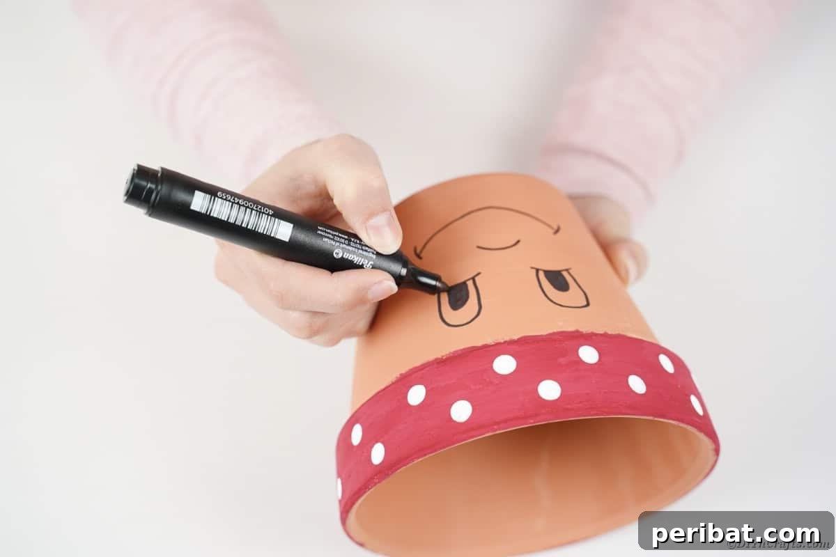 Drawing a charming face onto a flower pot