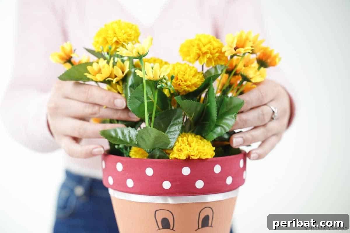 Adding vibrant flowers to the top of the flower pot head