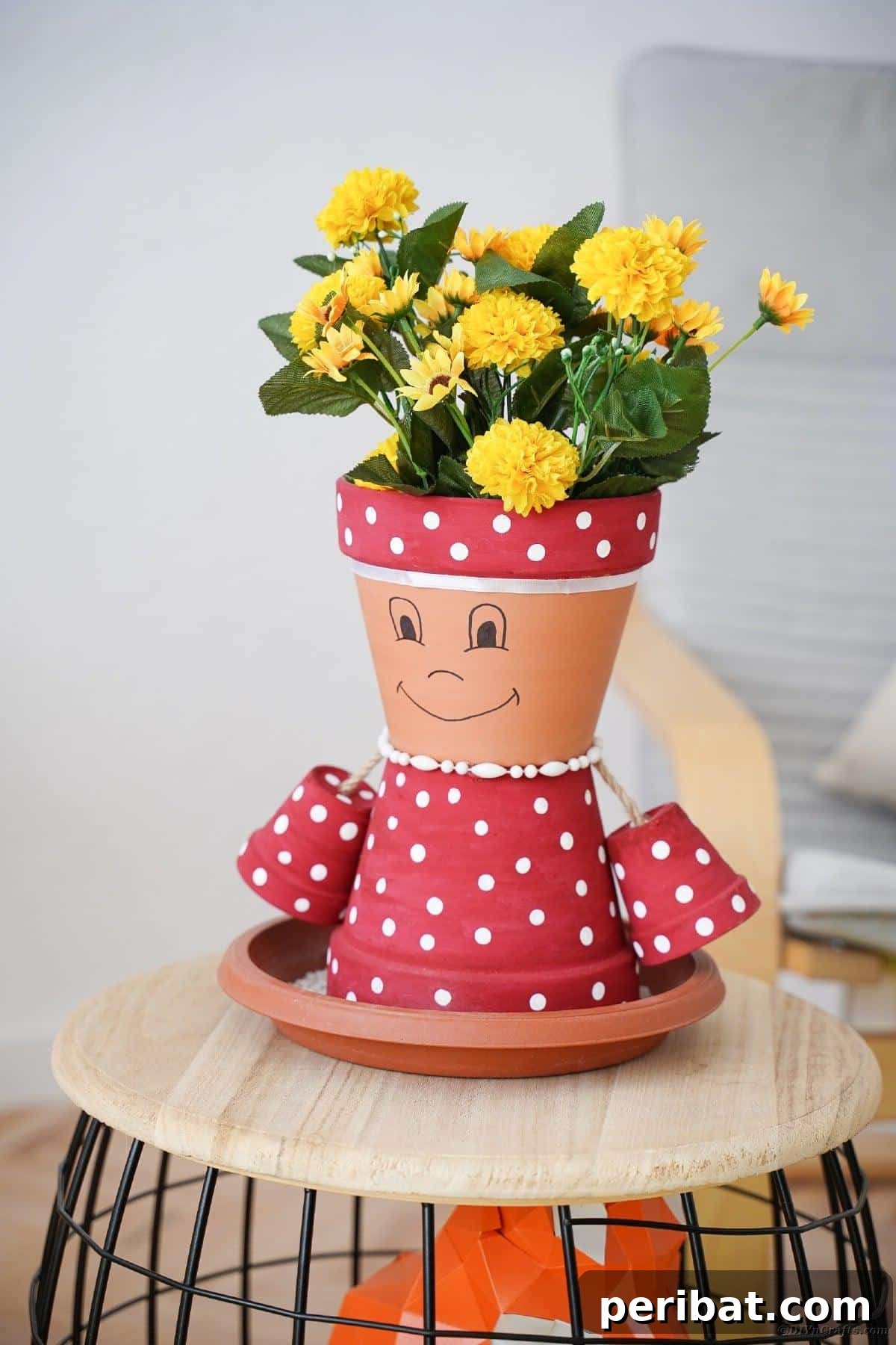 Close-up of a Pink and White Polka Dot Clay Pot Person on a Stool