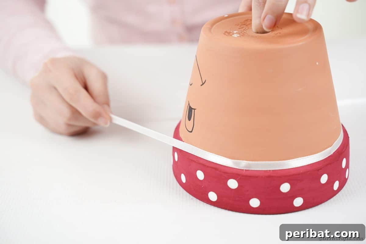 Adding ribbon to a large flower pot