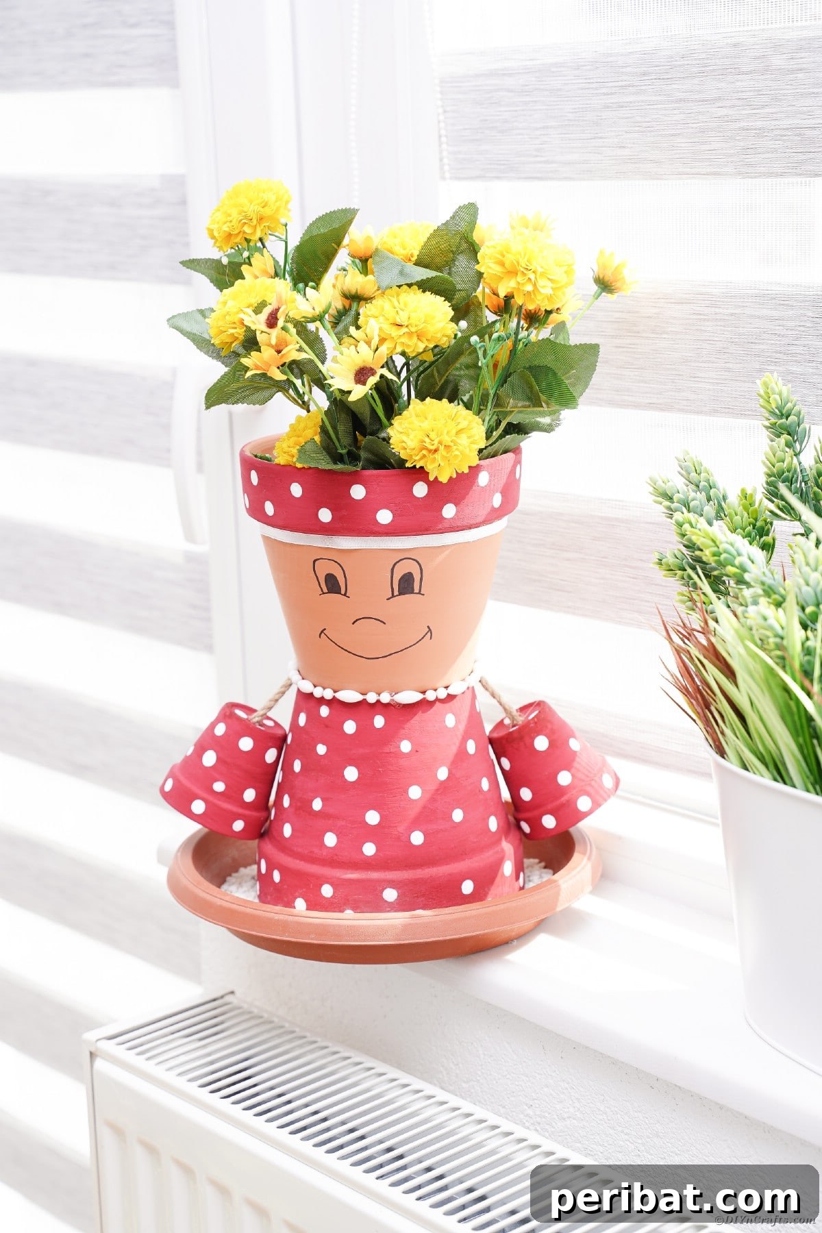 Pink polka dot flower pot in windowsill