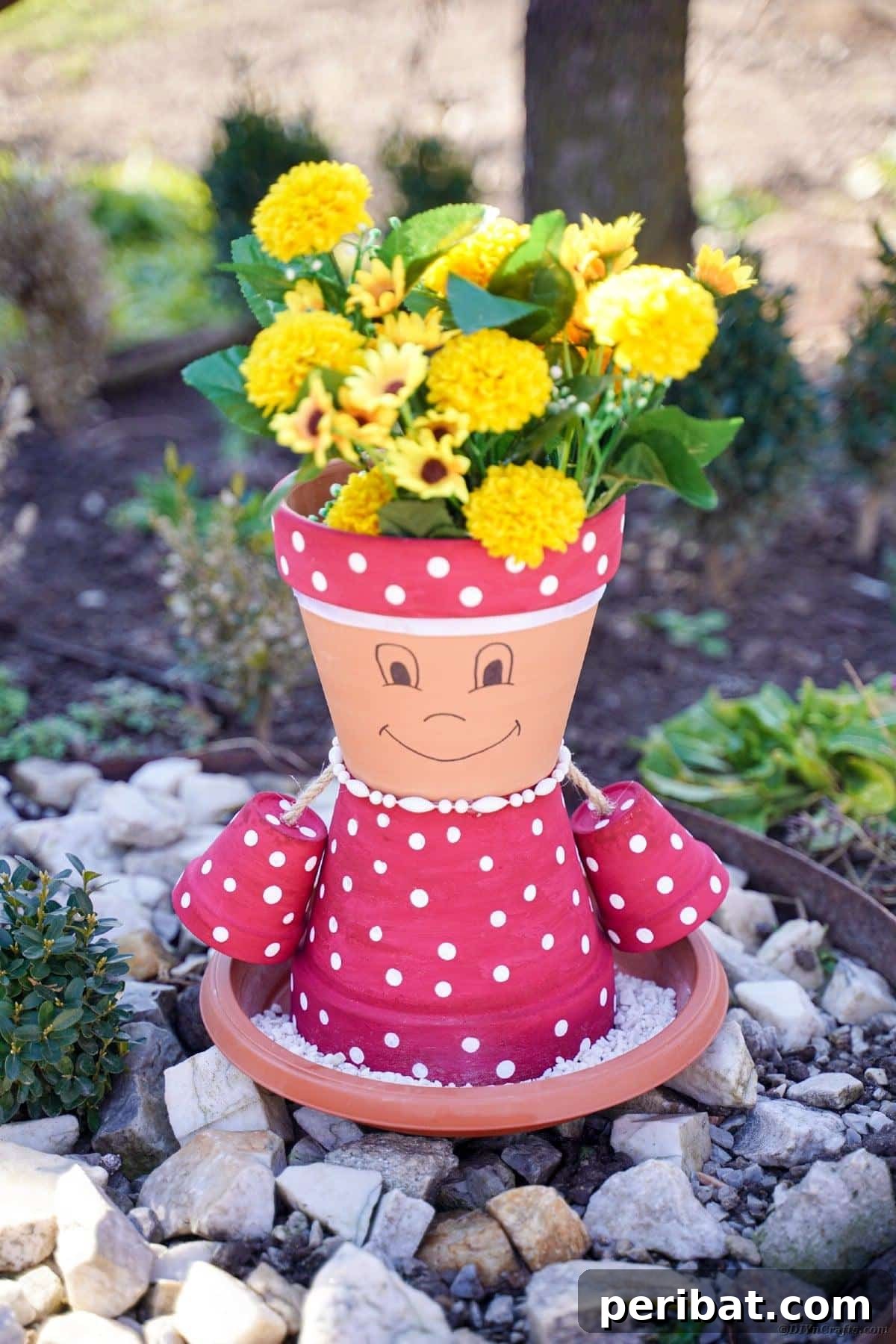 Whimsical Flower Pot Person Resting on Rocks Outdoors