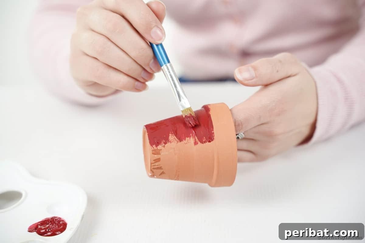 Painting a small terra cotta flower pot pink