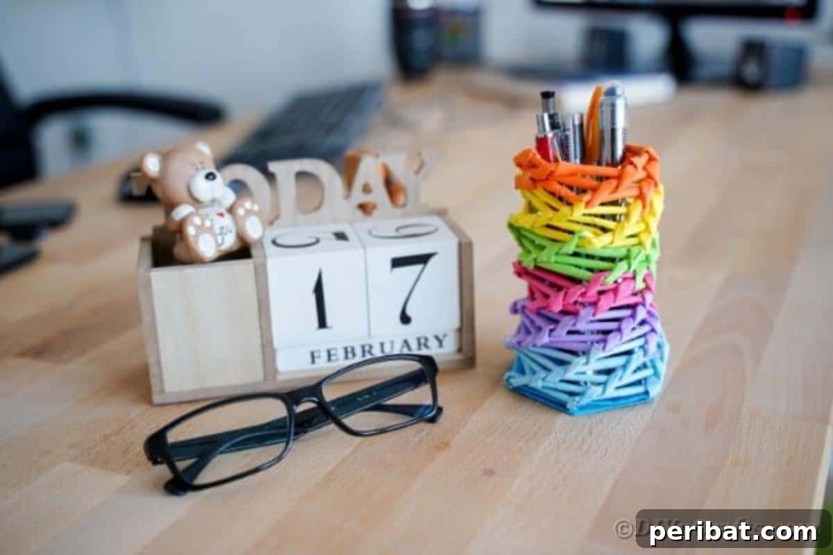Vibrant DIY Paper Straw Desk Caddy 3 Completed rainbow pencil holder on a desk next to a block calendar, showcasing its utility and aesthetic appeal.
