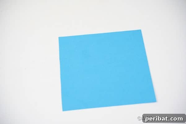 Vibrant DIY Paper Straw Desk Caddy 34 Square of blue paper on table