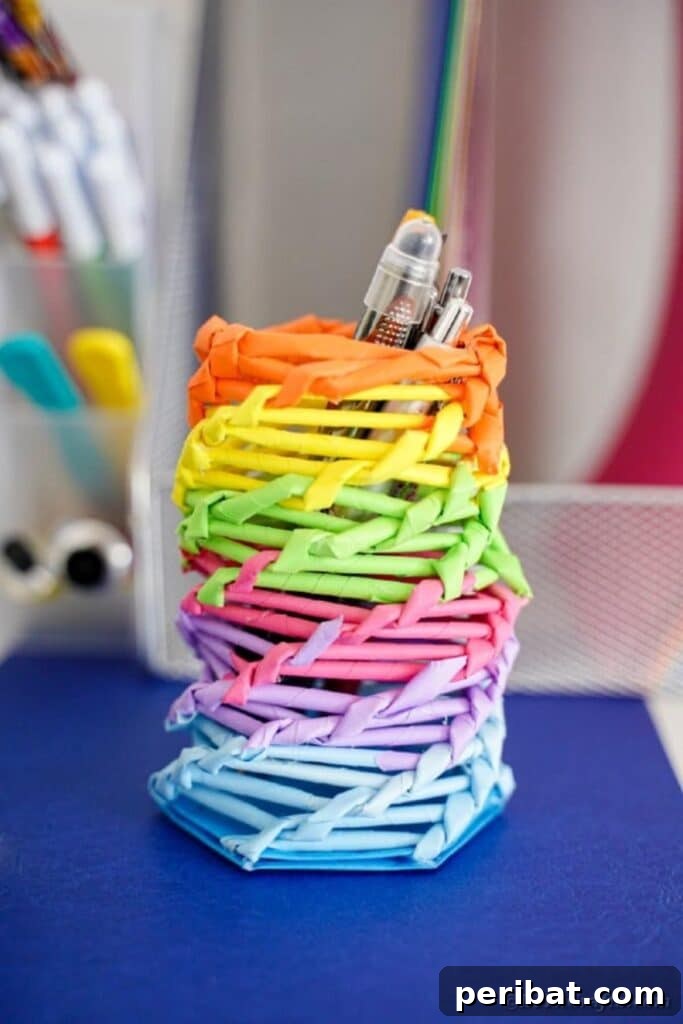 Vibrant DIY Paper Straw Desk Caddy 42 Rainbow organizer can on desk near papers, side view