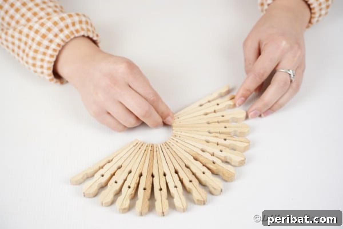 Chic Repurposed Clothespin Napkin Rack 11 A second identical half-circle structure of glued clothespin units is shown, mirroring the first one completed.