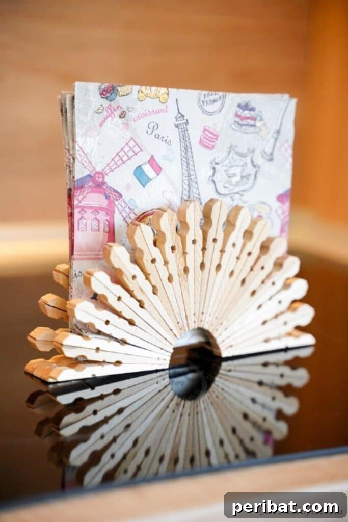Chic Repurposed Clothespin Napkin Rack 16 The rustic clothespin napkin holder is displayed on a dark table, highlighting its natural textures and aesthetic.