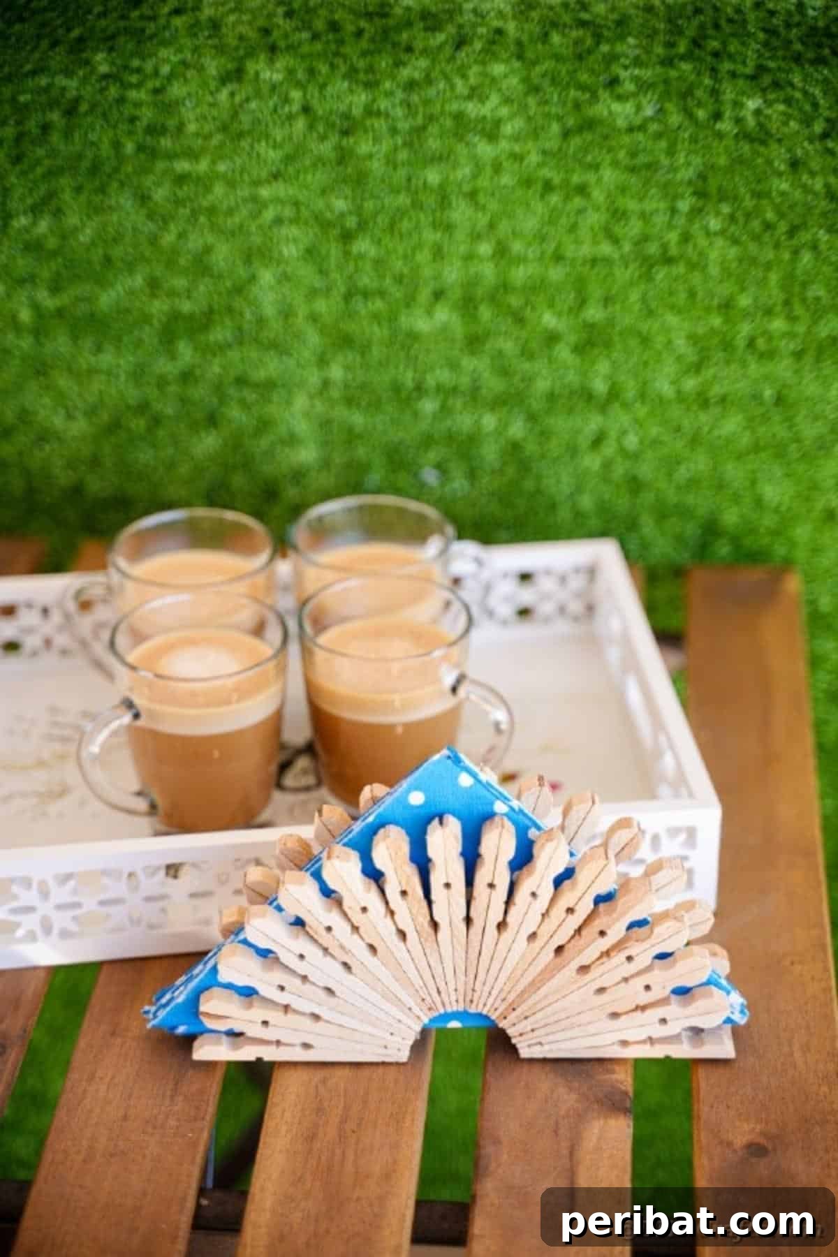 Chic Repurposed Clothespin Napkin Rack 5 The completed clothespin napkin holder sits elegantly on a table, accompanied by coffee cups, suggesting its role in a cozy setting.