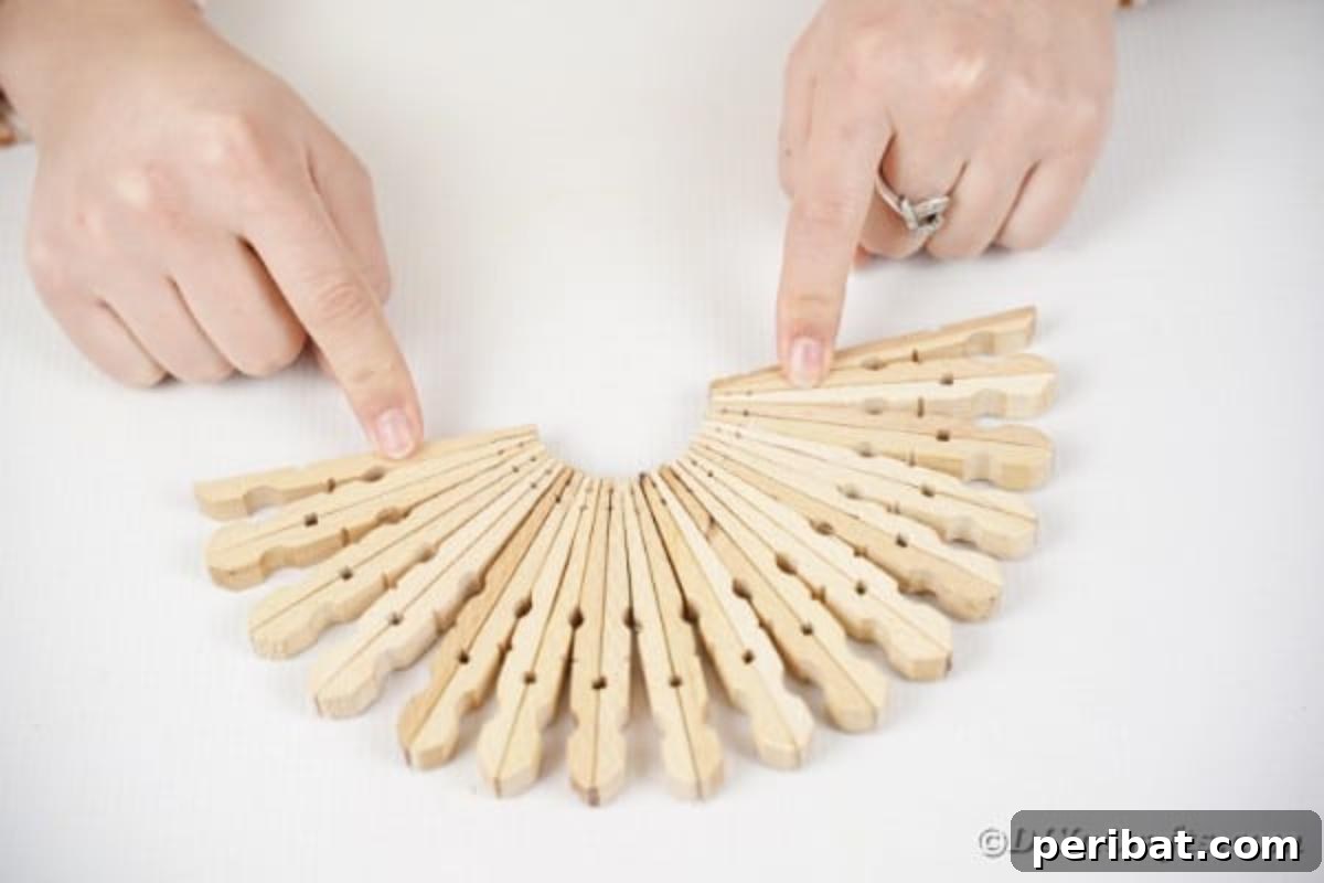 Chic Repurposed Clothespin Napkin Rack 10 A half-circle structure is being formed by gluing multiple double-sided clothespin units together, showing the curvature.