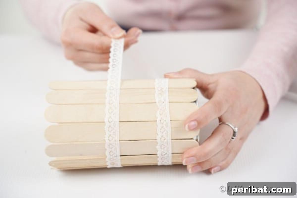 Transform Tin Cans into a Rustic Craft Stick Organizer Video Tutorial 12 Applying a second layer of lace around the craft stick tin can