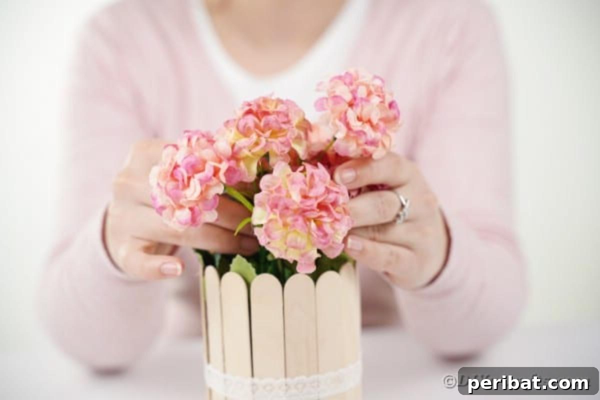 Transform Tin Cans into a Rustic Craft Stick Organizer Video Tutorial 13 Woman arranging flowers in the finished craft stick can organizer