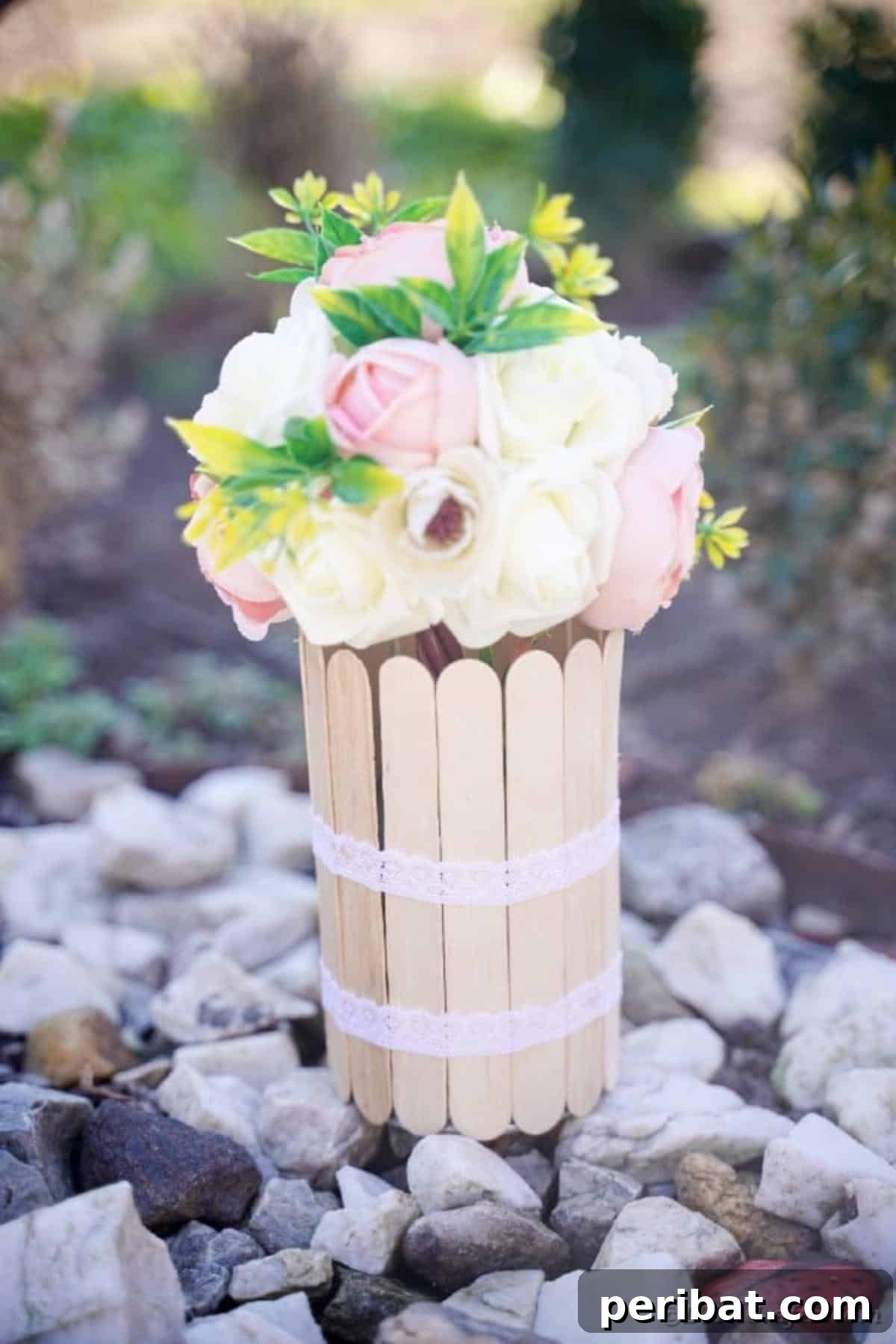 Transform Tin Cans into a Rustic Craft Stick Organizer Video Tutorial 7 Craft stick can placed on pebbles outdoors, highlighting its rustic appeal