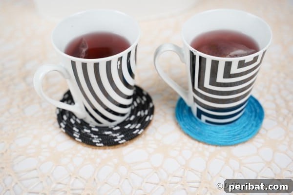 Black and white and blue coaster on table by potted plant
