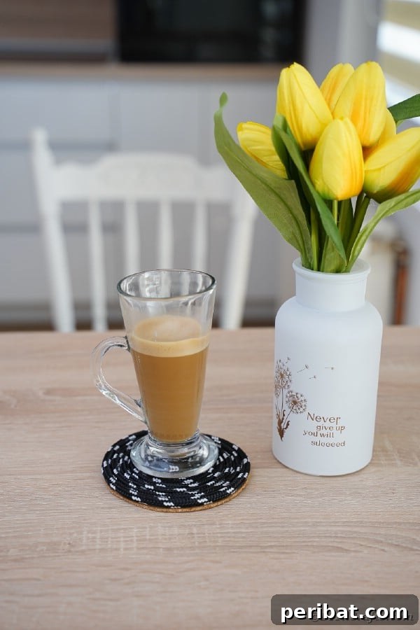 all glass of coffee on black rope coaster
