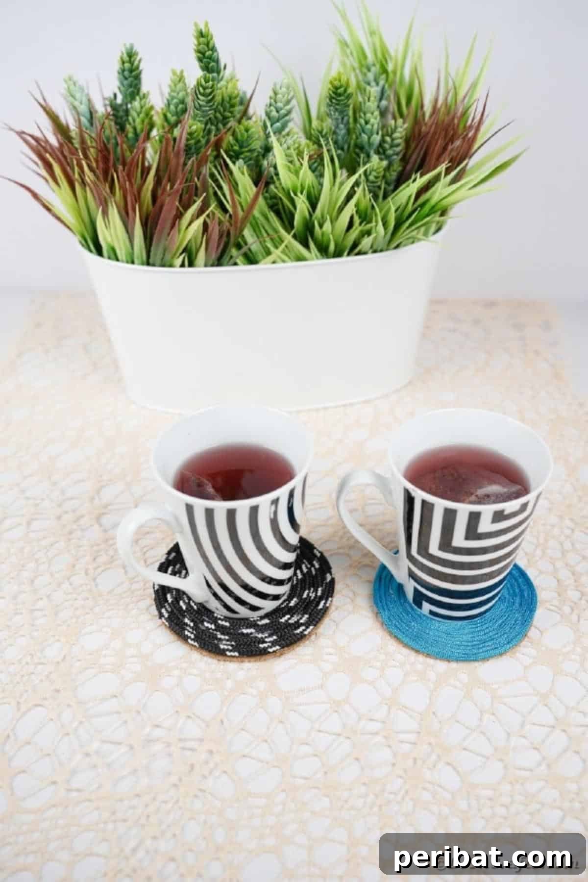 Black and white and blue coaster on table by potted plant