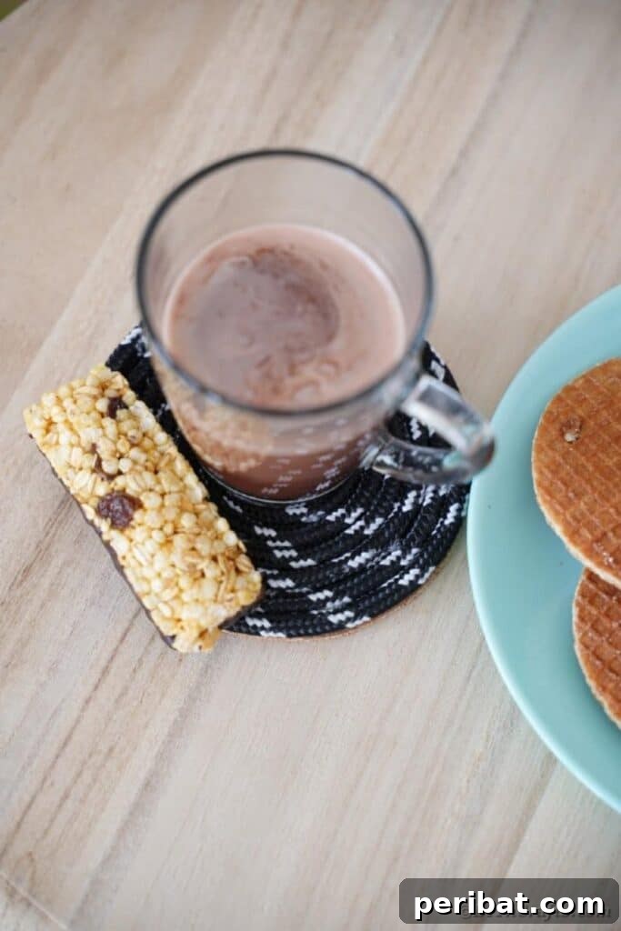Coffee cup on coaster by plate of waffles