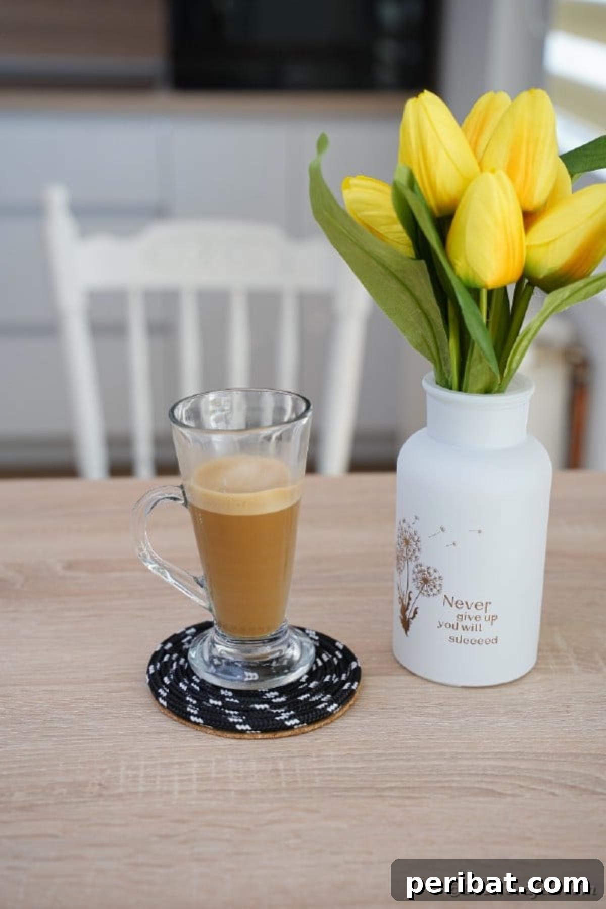 all glass of coffee on black rope coaster