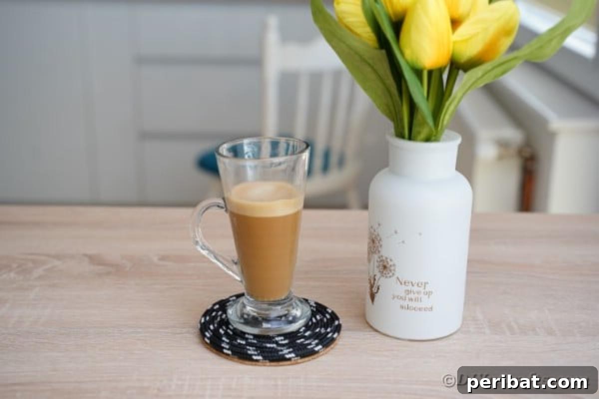 Tall glass of coffee on black rope coaster
