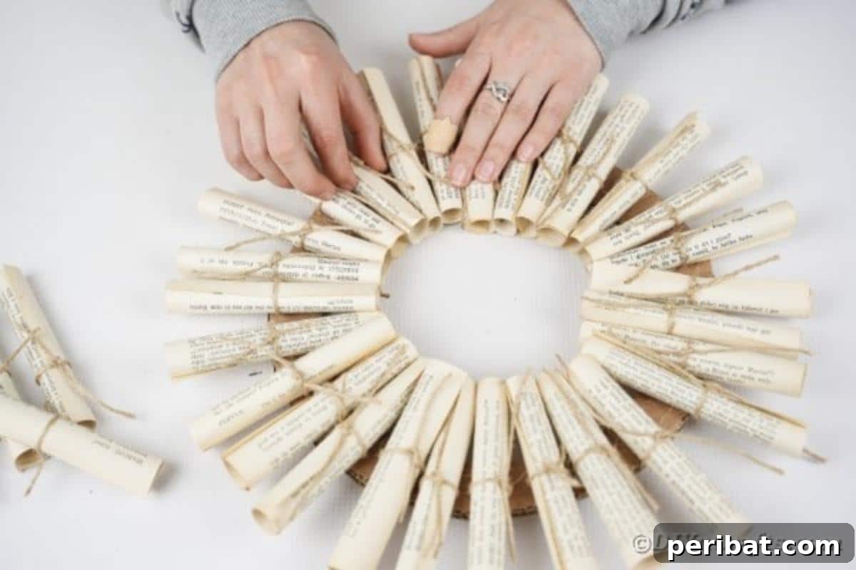 Artful Scroll Wreath from Repurposed Book Pages 19 Gluing paper scrolls around cardboard