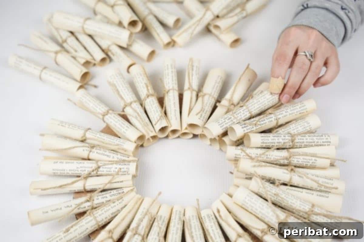 Artful Scroll Wreath from Repurposed Book Pages 20 Gluing paper scrolls around cardboard