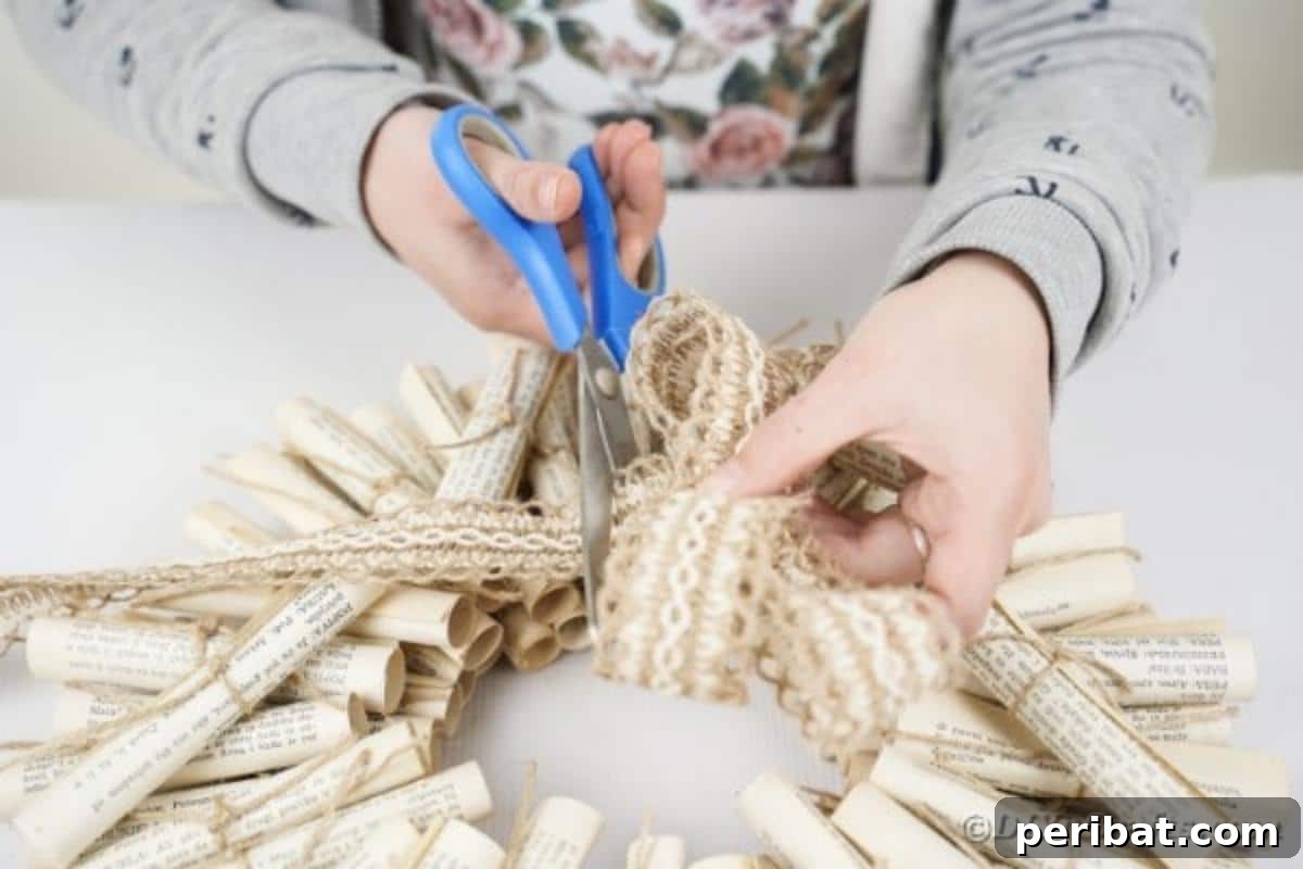 Artful Scroll Wreath from Repurposed Book Pages 22 Cutting ribbon for a bow