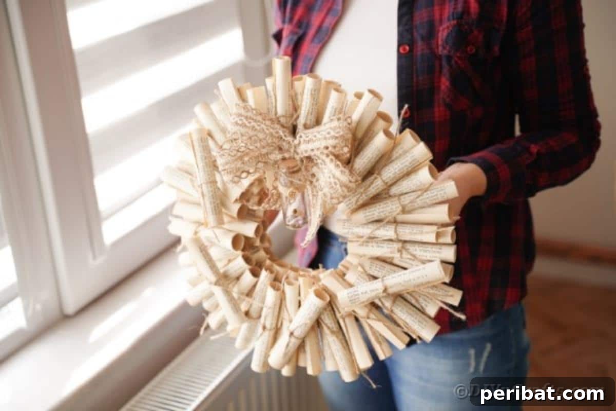 Artful Scroll Wreath from Repurposed Book Pages 4 Woman holding an old book page wreath