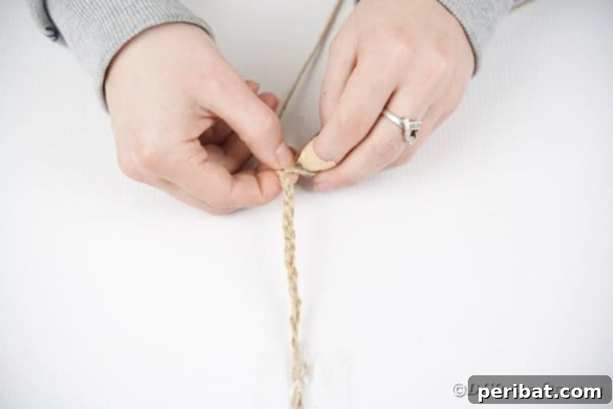 Fourth step: Braiding three strands of twine to create a decorative border for the coaster.