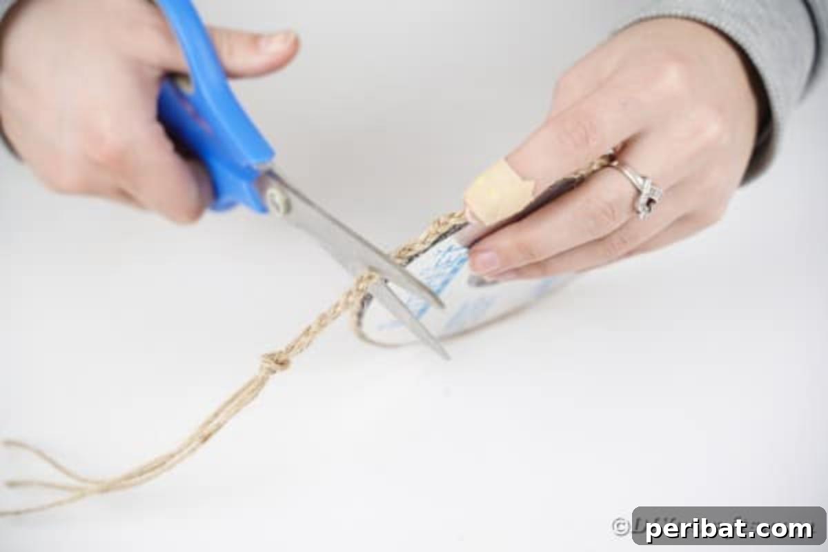 Sixth step: Trimming excess braided twine and securing the end with hot glue for a neat finish.