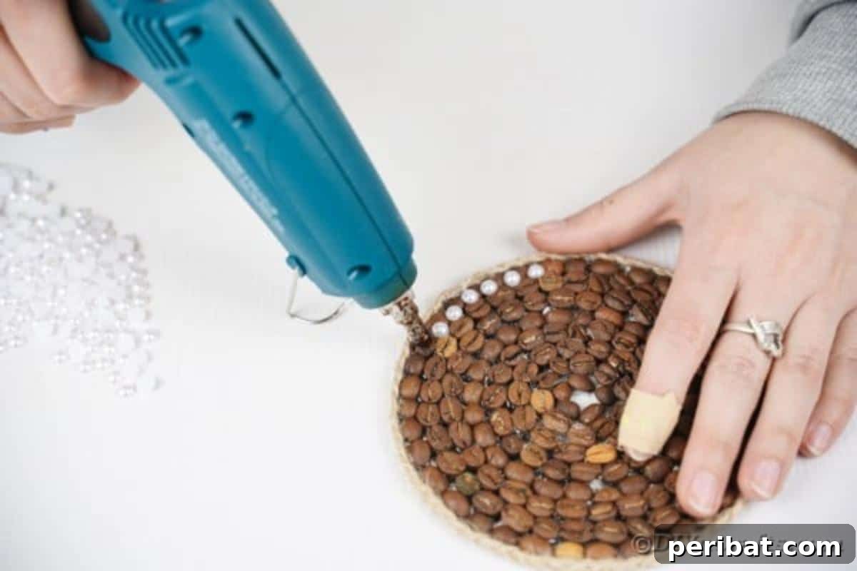 Seventh step: Adding decorative beads or rhinestones with small dots of glue along the coaster's outer edge.